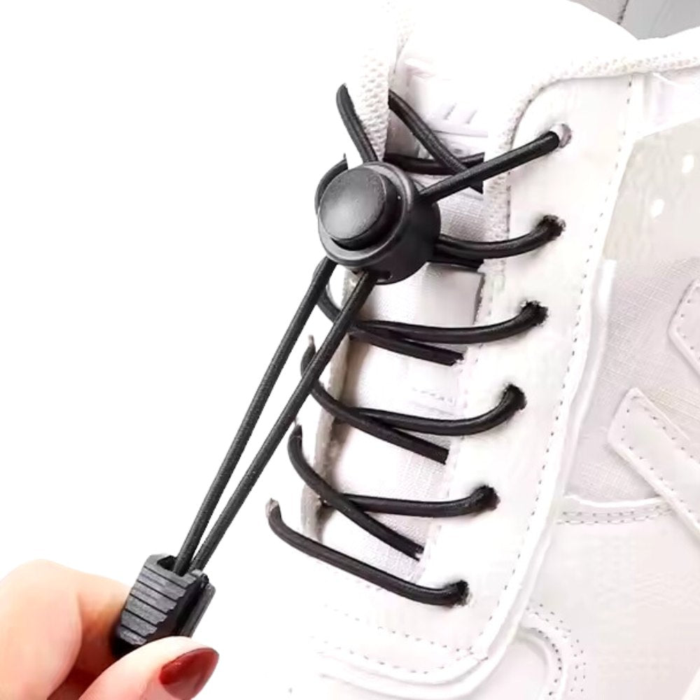 Black round elastic no-tie shoelaces with an adjustable lock displayed on white sneakers